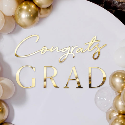 Novabright Congrats Grad Sign backdrop in gold acrylic mirrors for elegant graduation photos.