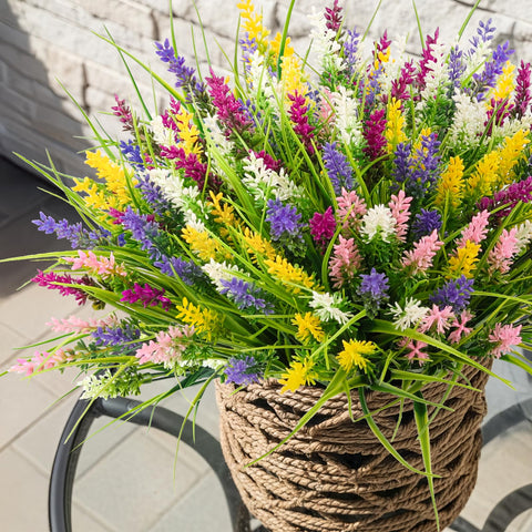 NT NIETING artificial grass with yellow flowers brightens walkways and patios.
