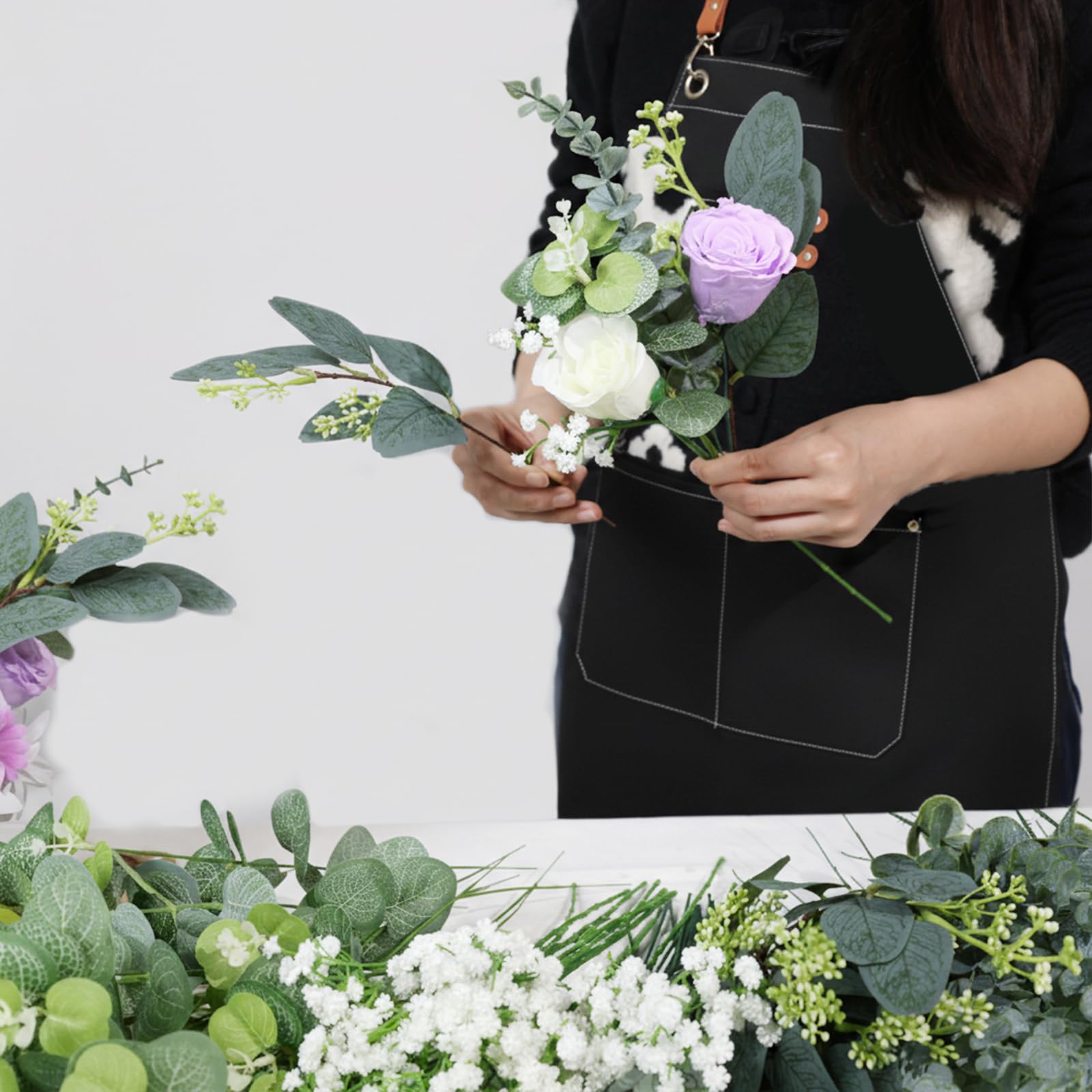 N&T NIETING greenery stems provide timeless faux greenery for setups.