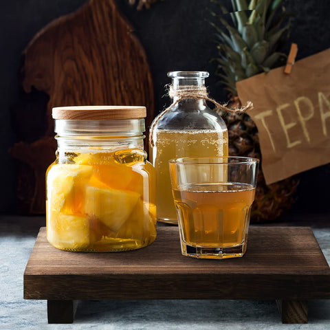 Nuogo wood riser tray elevates bottles and candles in any room.