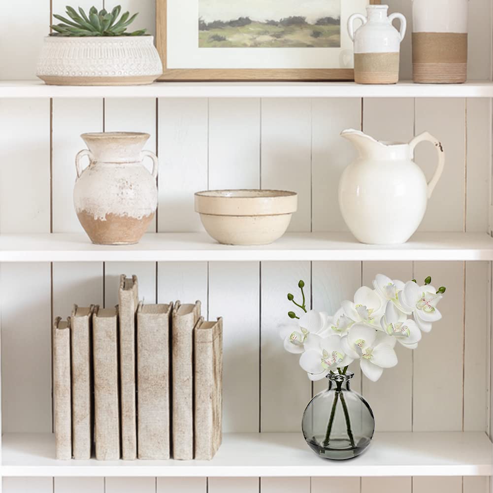 Oairse white orchid centerpieces brighten bedrooms or foyers.