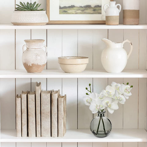 Oairse white orchid centerpieces brighten bedrooms or foyers.