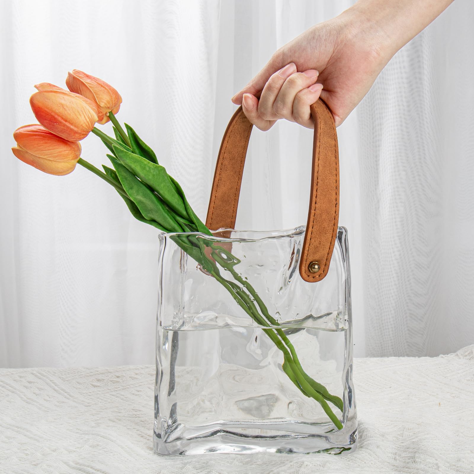 Oairse glass purse vase with dried stems setup displaying versatile filler options.