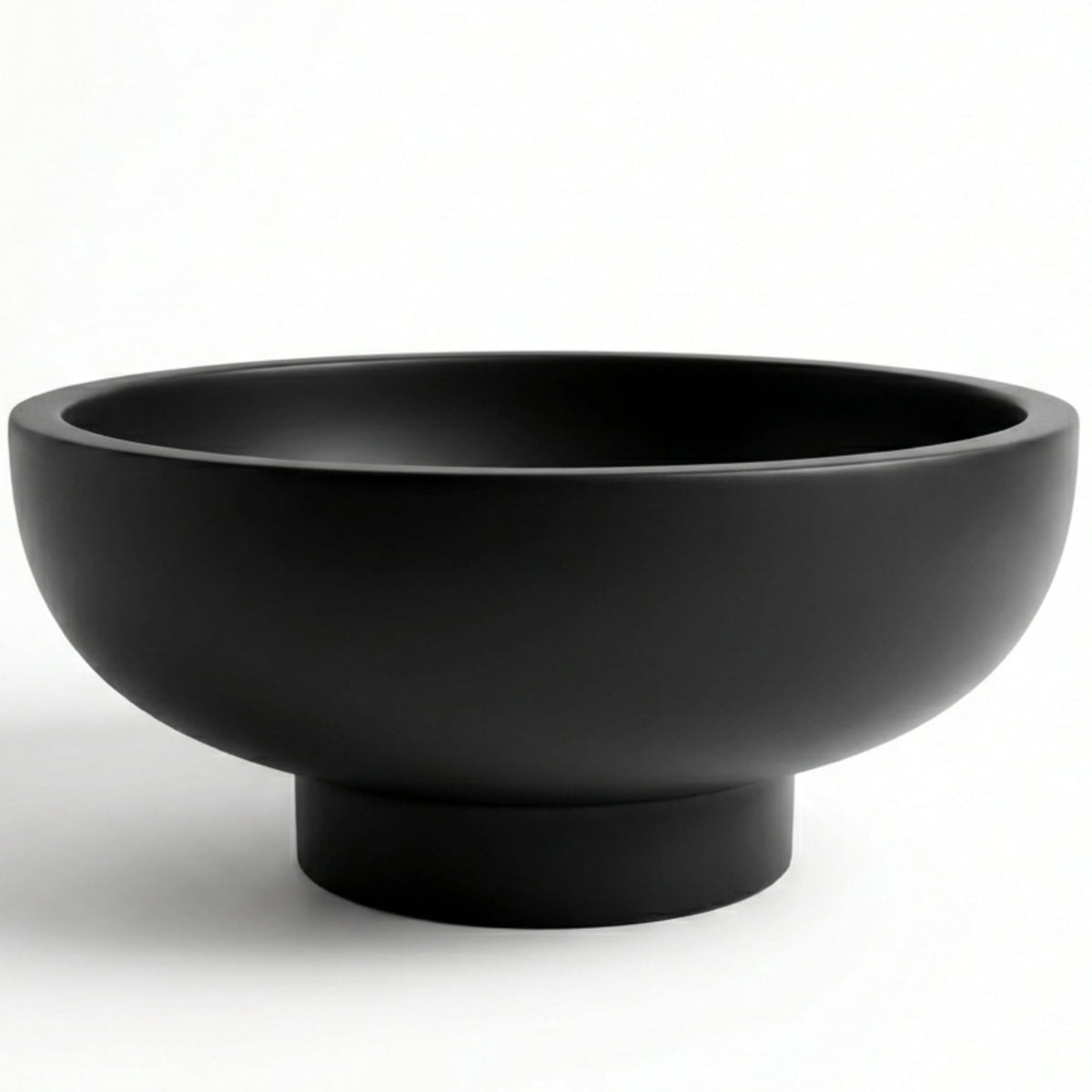 OAKOA concrete bowl with unique artwork enhances fruit display.