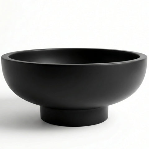 OAKOA concrete bowl with unique artwork enhances fruit display.