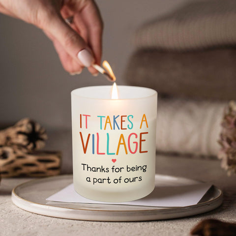 OASSIE 10oz candle glowing softly on a desk