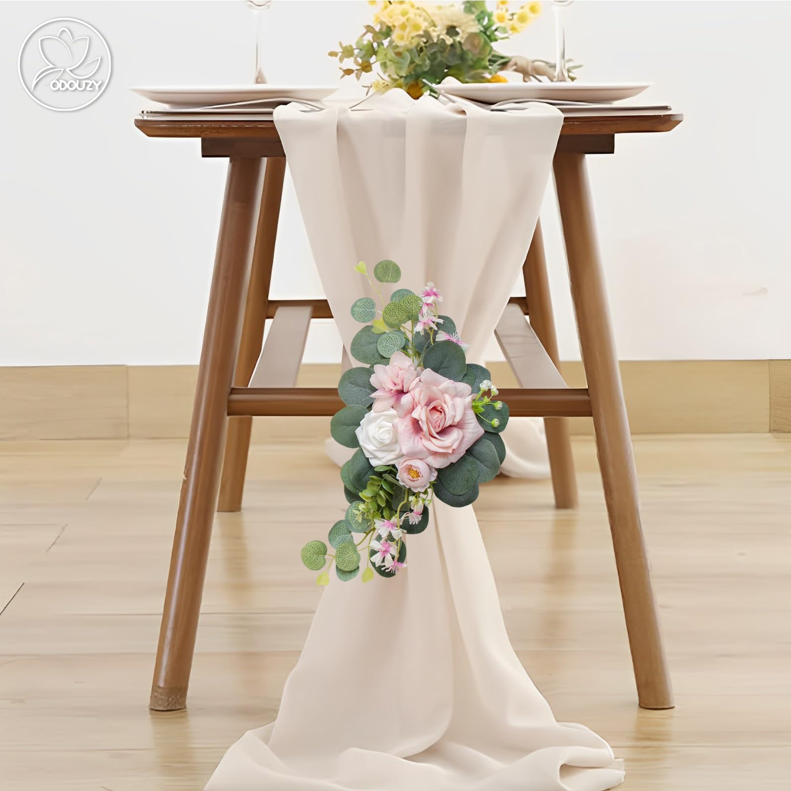 Odouzy floral garland pairs well with greenery for a charming ceremony entry.