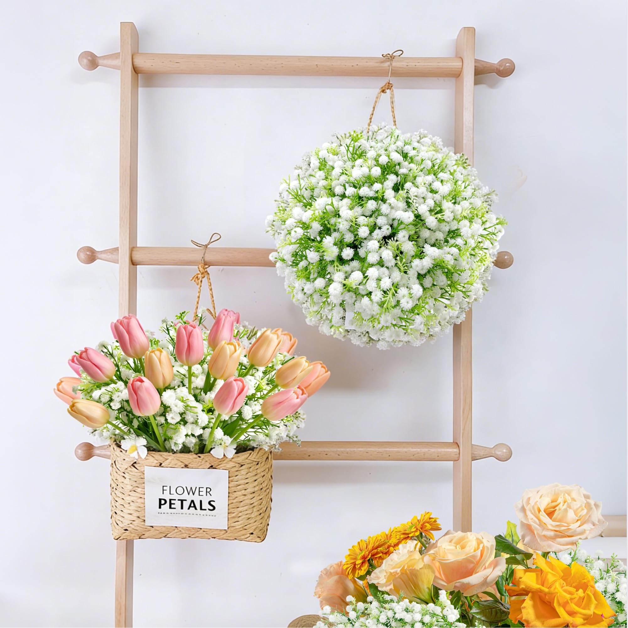 Ofrence white gypsophila complements roses and eucalyptus for layered arrangements.