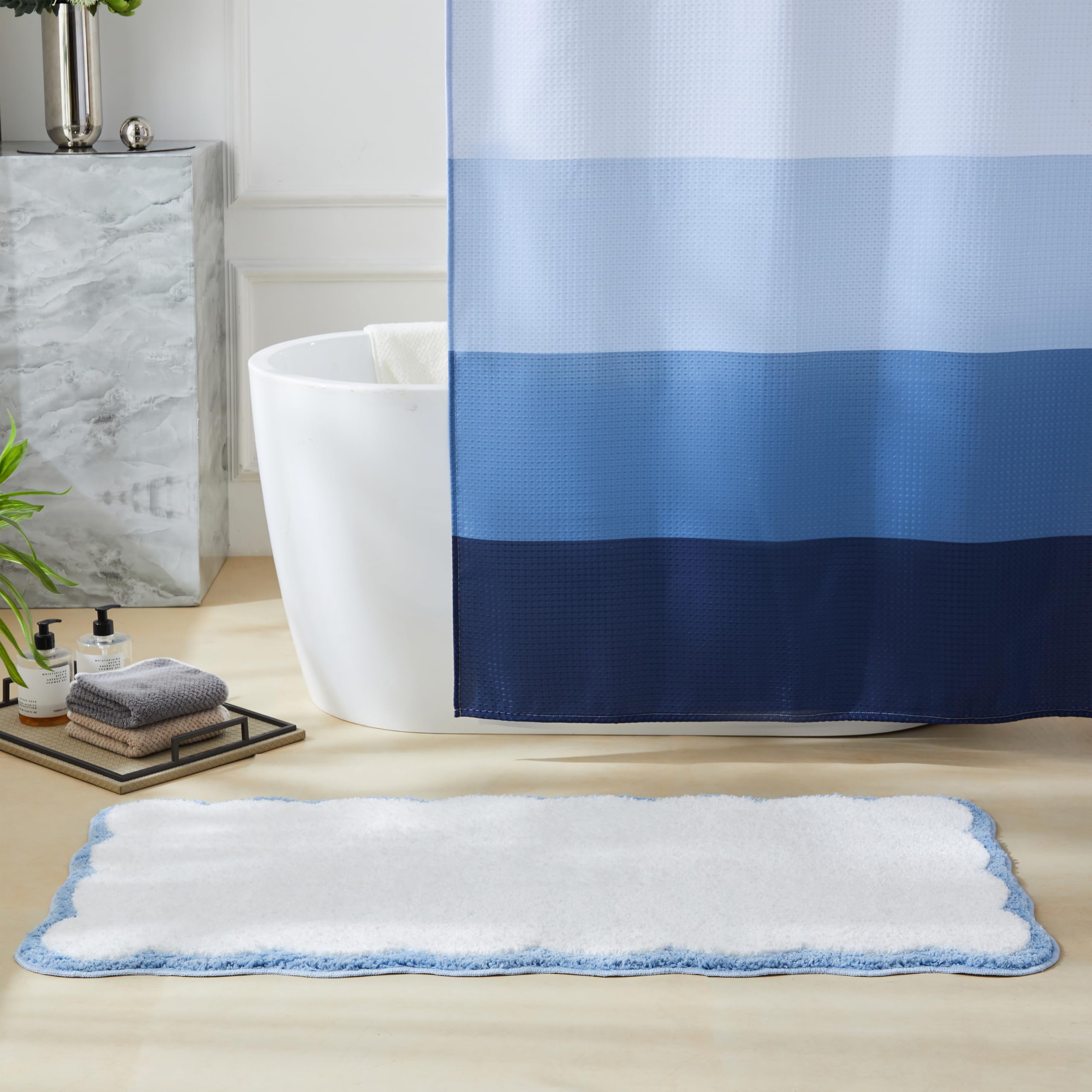 Ohocut white bath mat with blue scalloped piping complements modern bathrooms