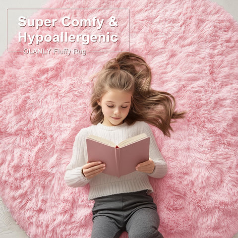 OLANLY pink round rug with non-slip base for stable placement on floors.