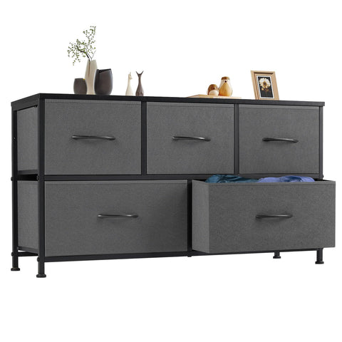 OLIXIS dresser with five drawers shown in a bedroom, an organized storage solution.
