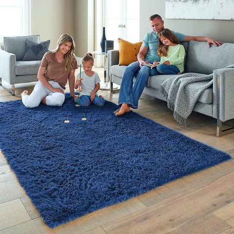 Ophanie navy playroom rug with plush texture creates a cozy play area.
