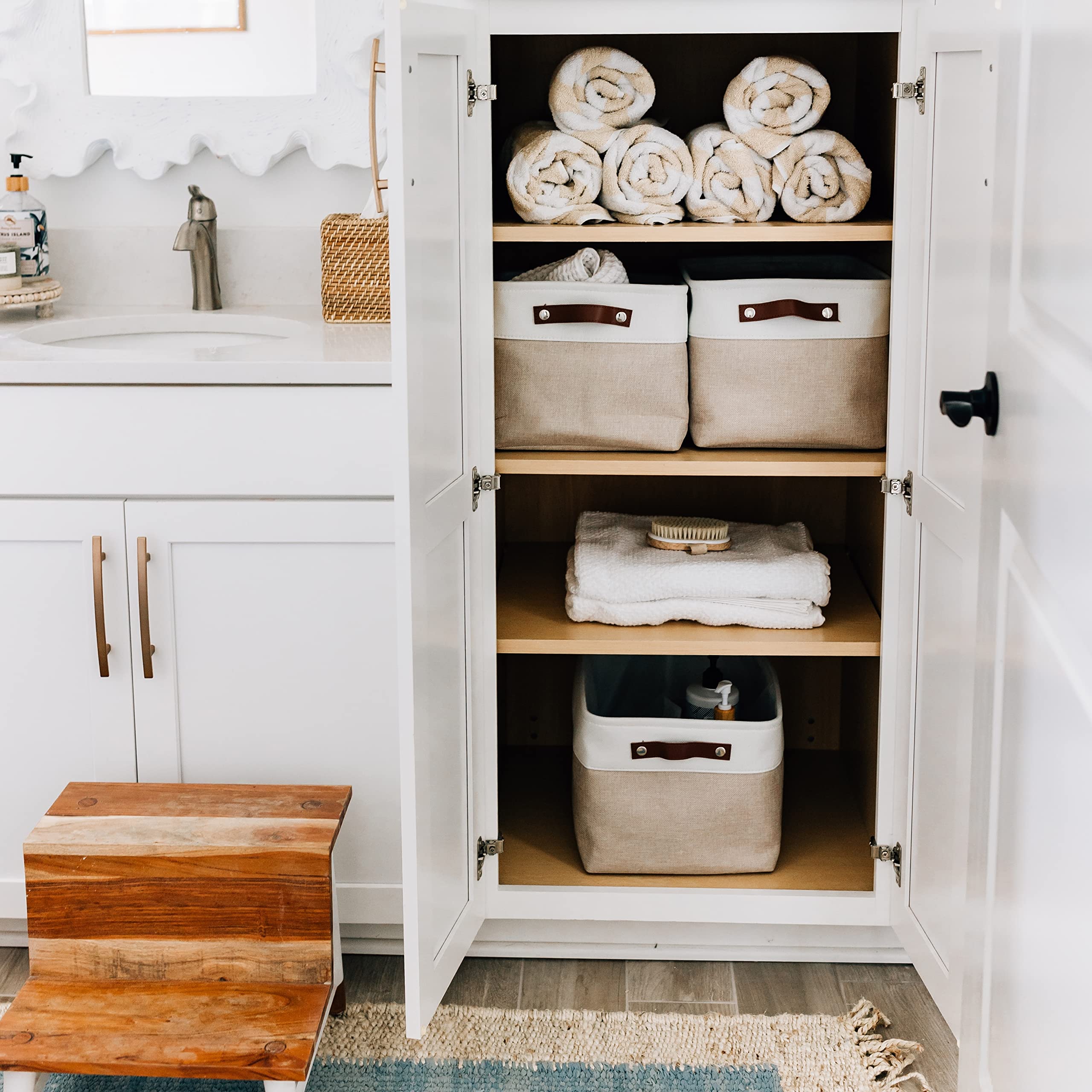 OrganiHaus linen closet bin holding towels and blankets with easy access.