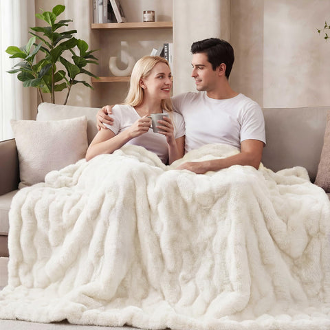 ORINOVA Light Beige Cozy Faux Fur Throw on bed adds fluffy comfort to bedrooms.