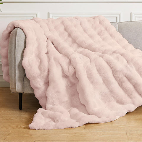 ORINOVA pink fluffy blanket on couch adds cozy warmth and chic decor