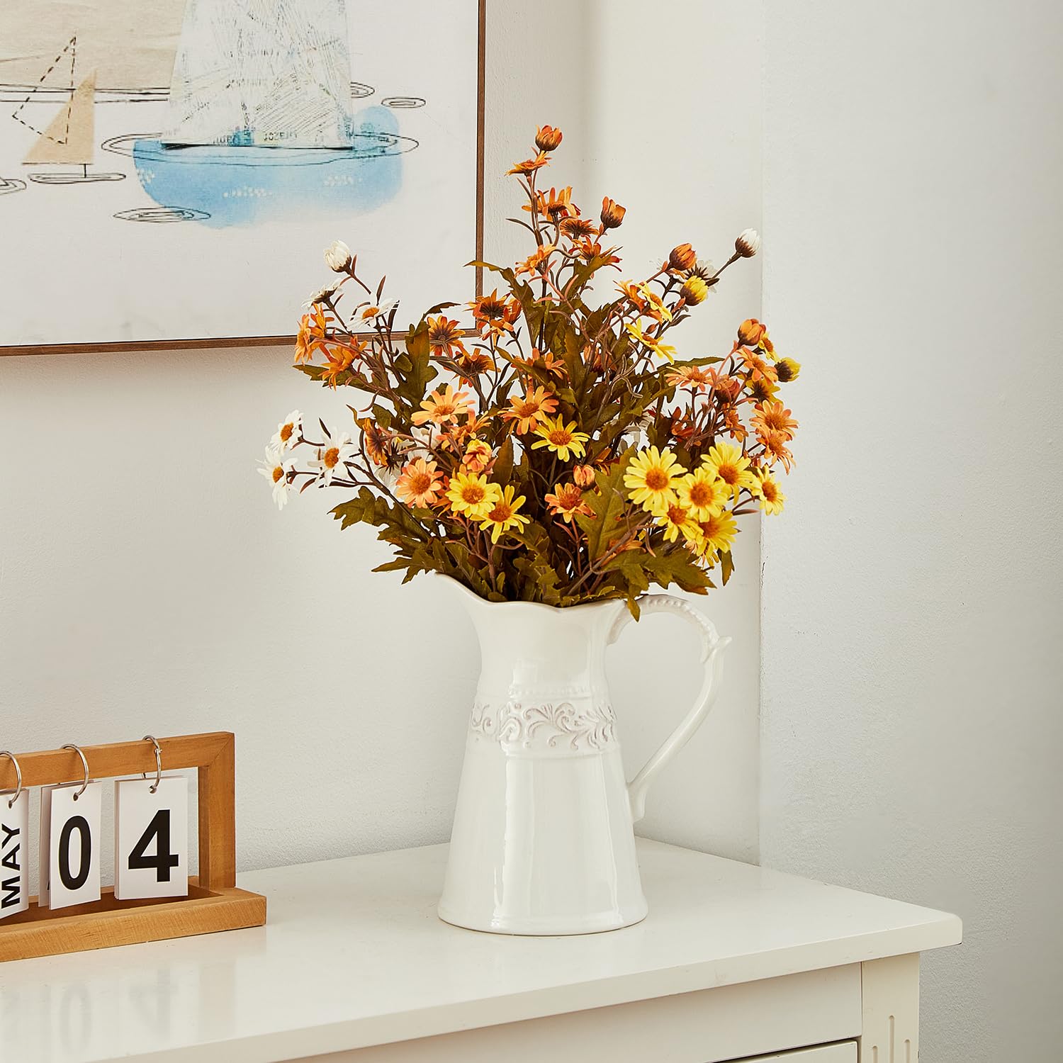 OTARTU white ceramic vase with flowers adds bright color to any room.