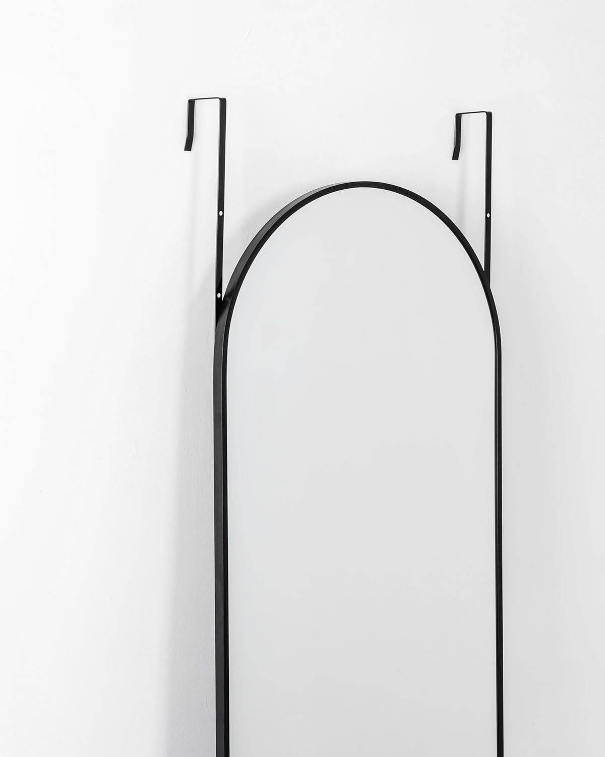 Otlsh arch mirror close-up shows slim black frame ideal for modern interiors.