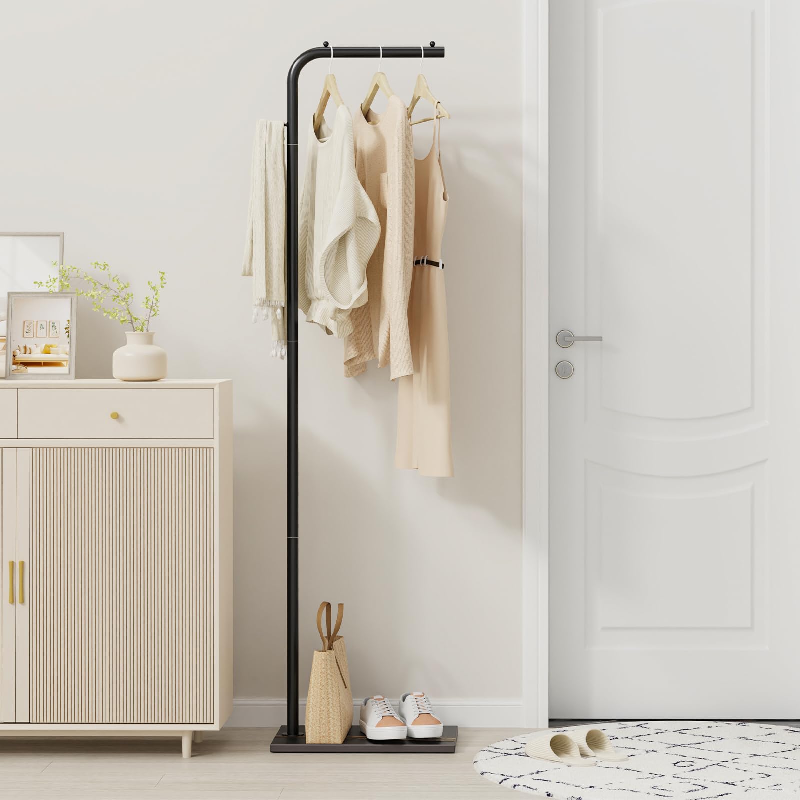 OUTBROS coat rack in a bedroom for convenient garment storage.