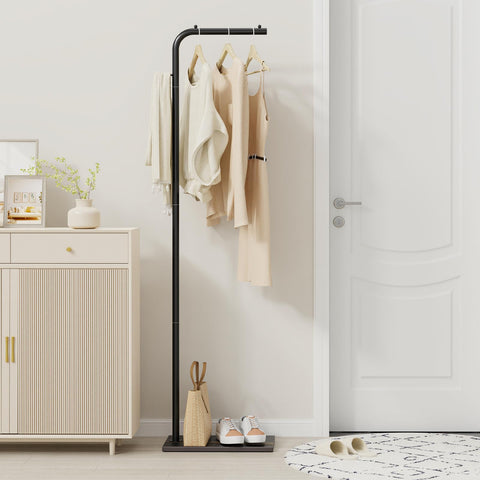 OUTBROS coat rack in a bedroom for convenient garment storage.