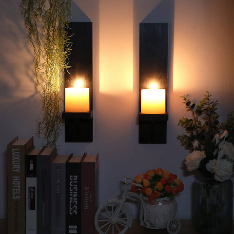 Rustic black wall mount sconce provides sturdy pillar candle support.