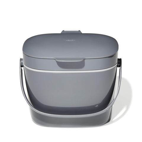 OXO Good Grips compost bin in charcoal on the counter for neat scraps.