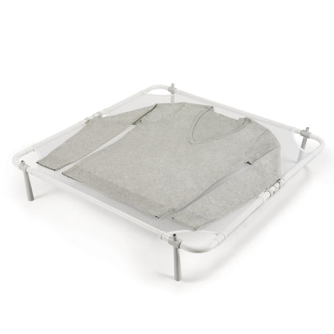 OXO Good Grips Folding Sweater Dryer on a clean table for delicate air drying