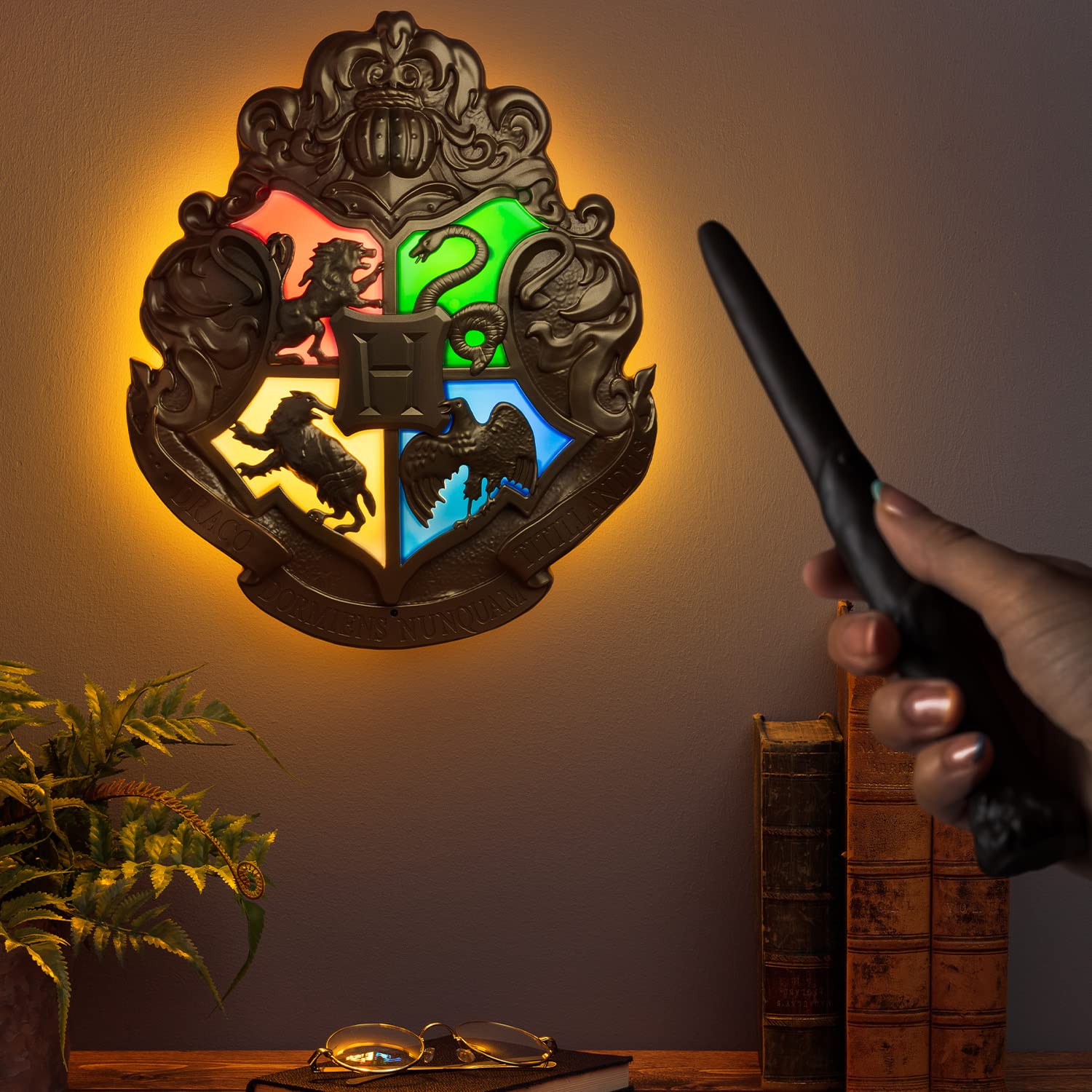 Paladone Hogwarts Crest lamp lit on a desk enhances focus