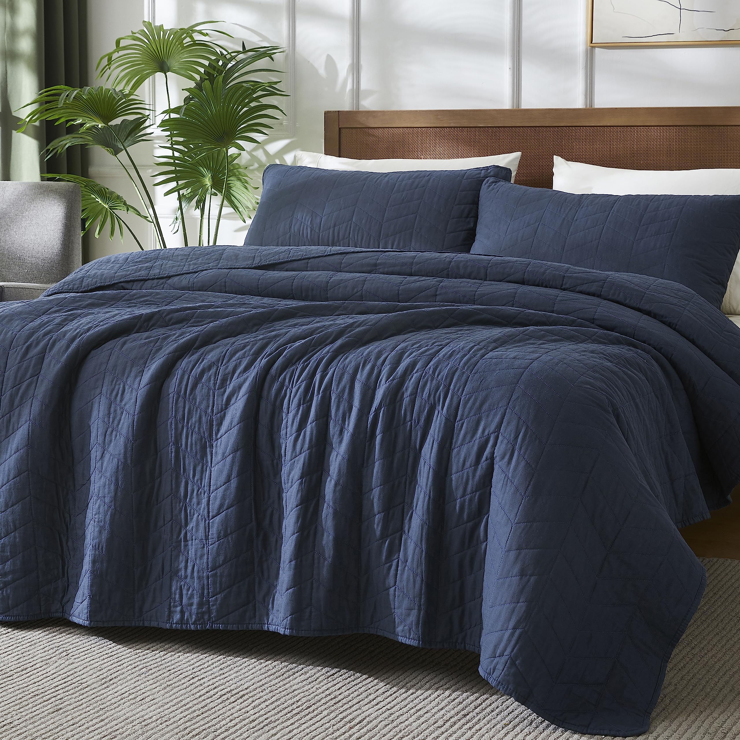 Palassio navy blue pillow sham complements twin bed setup with cohesive style.