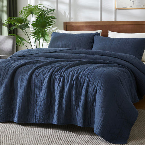 Palassio navy blue pillow sham complements twin bed setup with cohesive style.