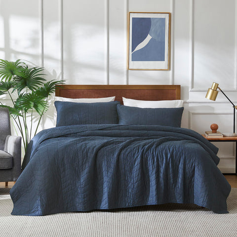 Palassio navy blue quilt twin coverlet shows smooth fabric for all-season warmth.