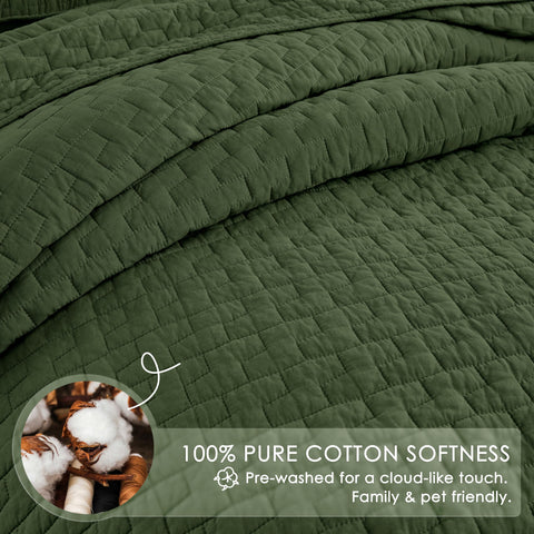 Palassio olive green quilt draped on bed in cozy bedroom.