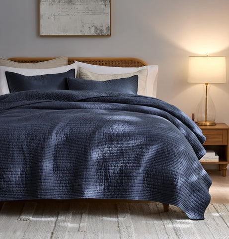 Palassio striped navy quilt on bed in queen size for all-season comfort
