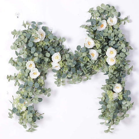 Party Joy eucalyptus garland with white roses for wedding backdrop and festive walls.