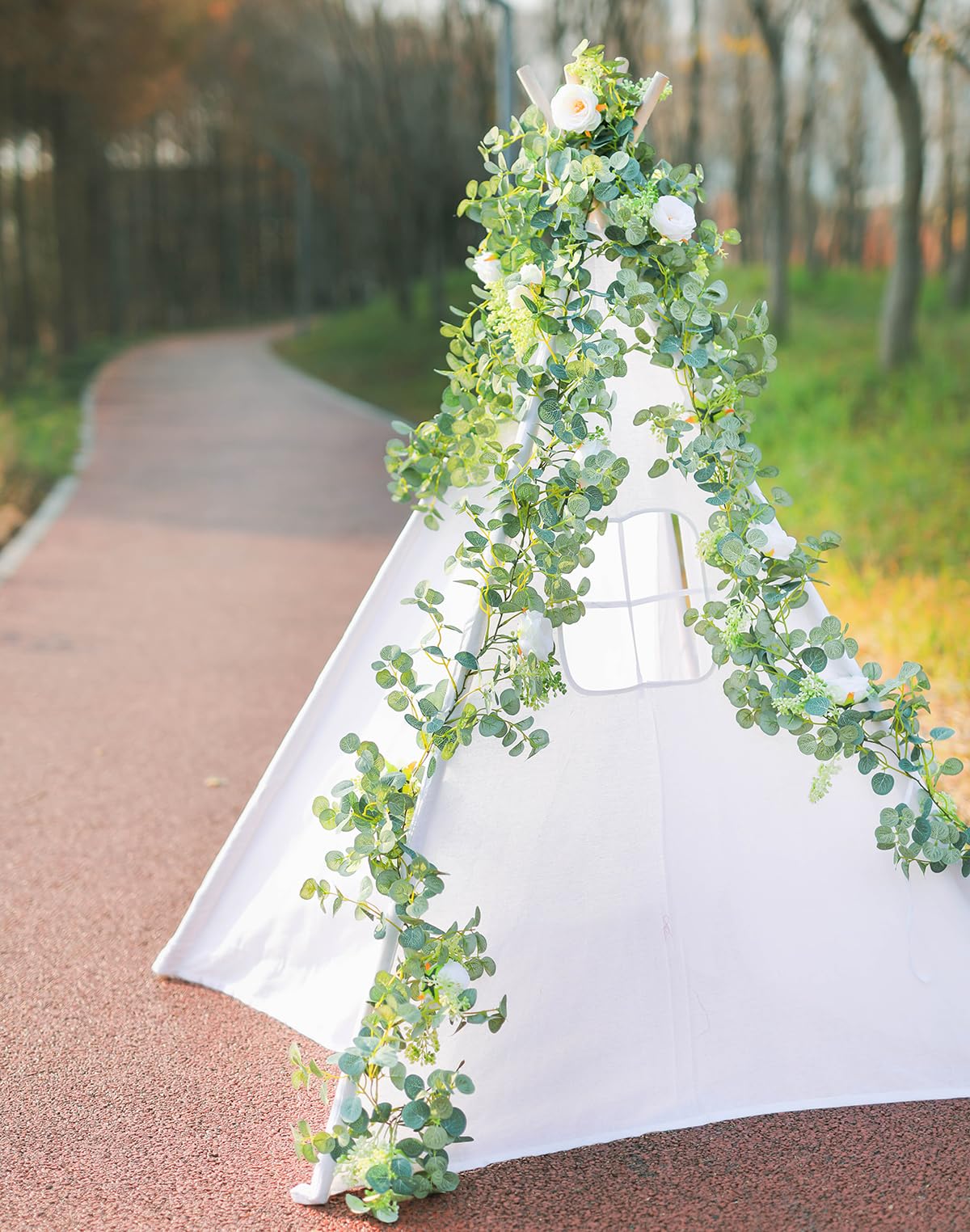 Party Joy eucalyptus garland outdoors backdrop creates lush ambiance.