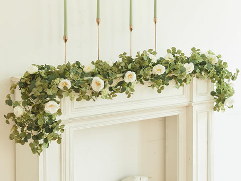 Party Joy eucalyptus garland on wedding arch for graceful ceremony backdrop.