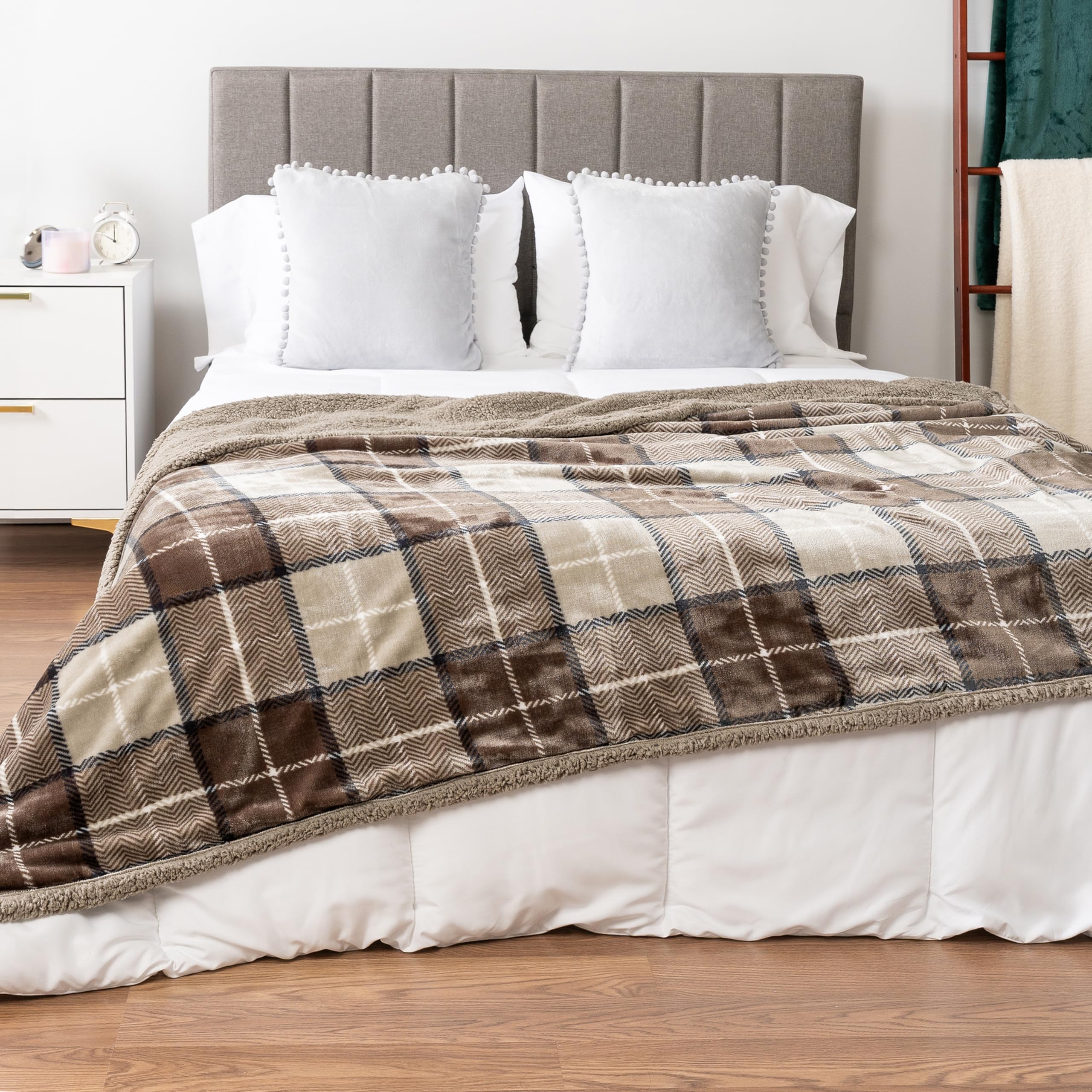 PAVILIA taupe plaid sherpa blanket draped on bed for elegant texture.
