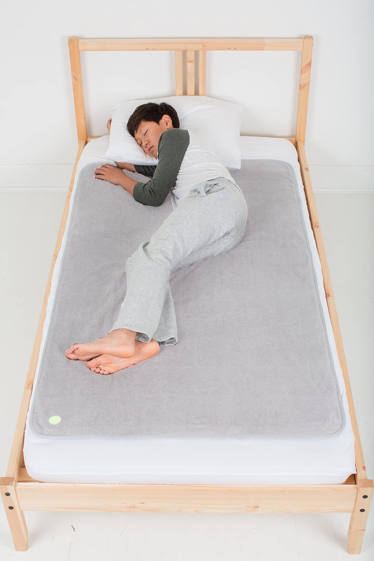 PeapodMats bedwetting underpad light gray top view offers reusable leakproof protection.