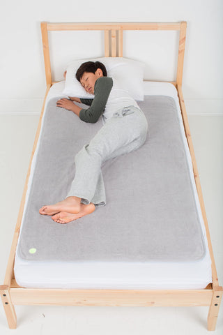 PeapodMats bedwetting underpad light gray top view offers reusable leakproof protection.