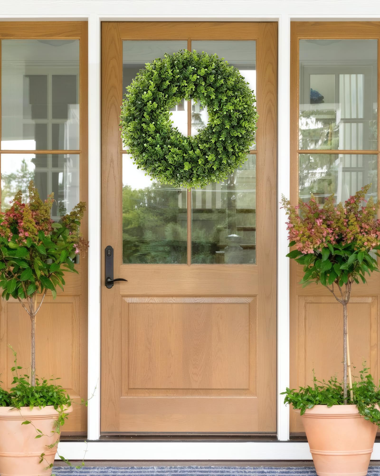 Petalyn boxwood wreath hanging on door for instant curb appeal.