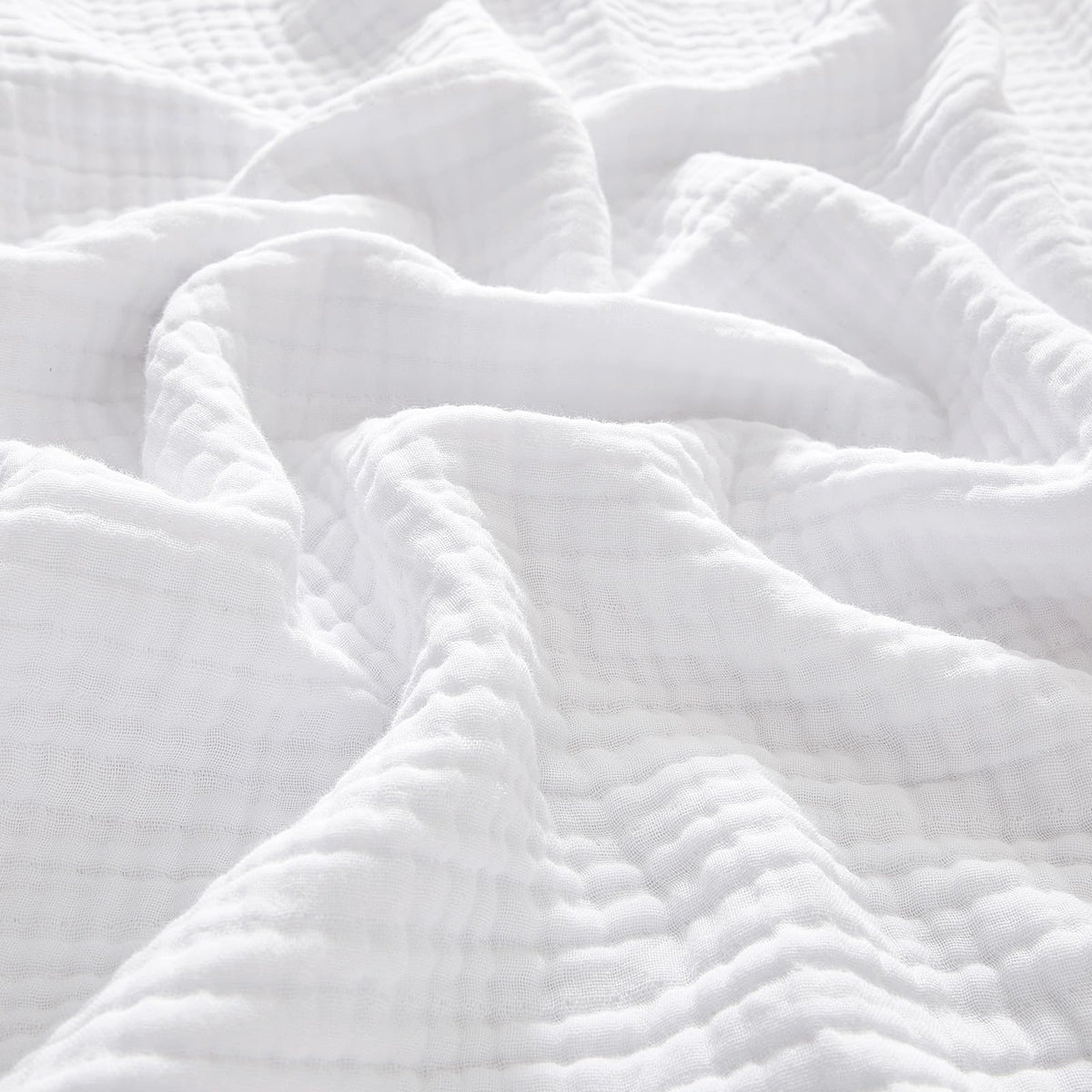 PHF muslin blanket king size on bed offering cozy coverage.