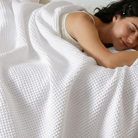 PHF pre-washed cotton waffle blanket on bed showing soft, breathable comfort.