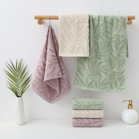 Pidada leaf-pattern towels folded on a bathroom rack for decor.