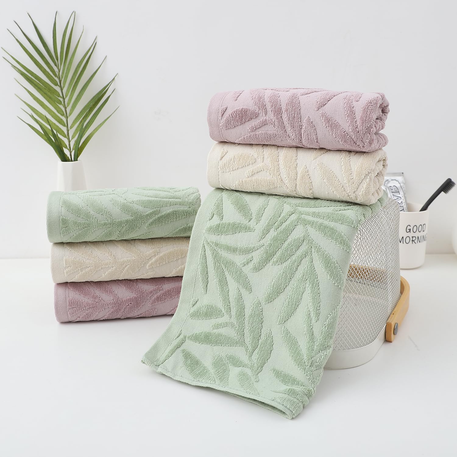 Pidada leaf-pattern towels arranged in a bath setup for spa-like vibe.