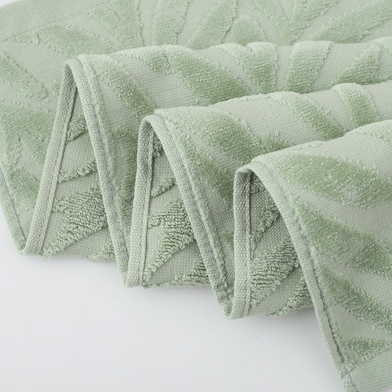 Pidada leaf-pattern towels brighten a vanity with elegant decor.
