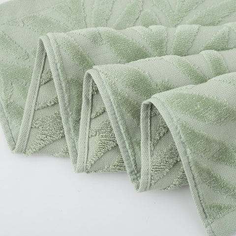Pidada leaf-pattern towels brighten a vanity with elegant decor.