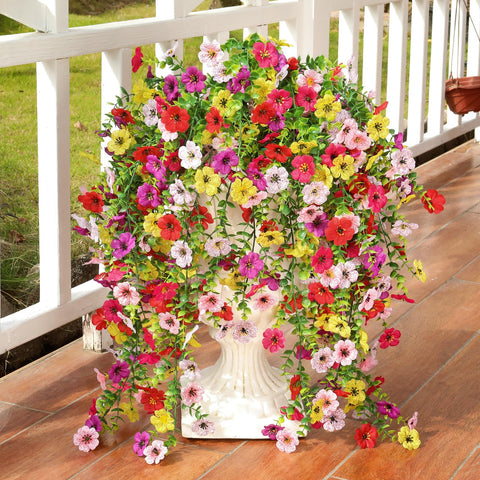 Playieer fake flowers with eucalyptus leaves add realistic texture to planters.