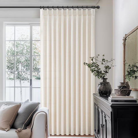 PleatedDrapes light-filtering linen curtains provide airy privacy in bedrooms.