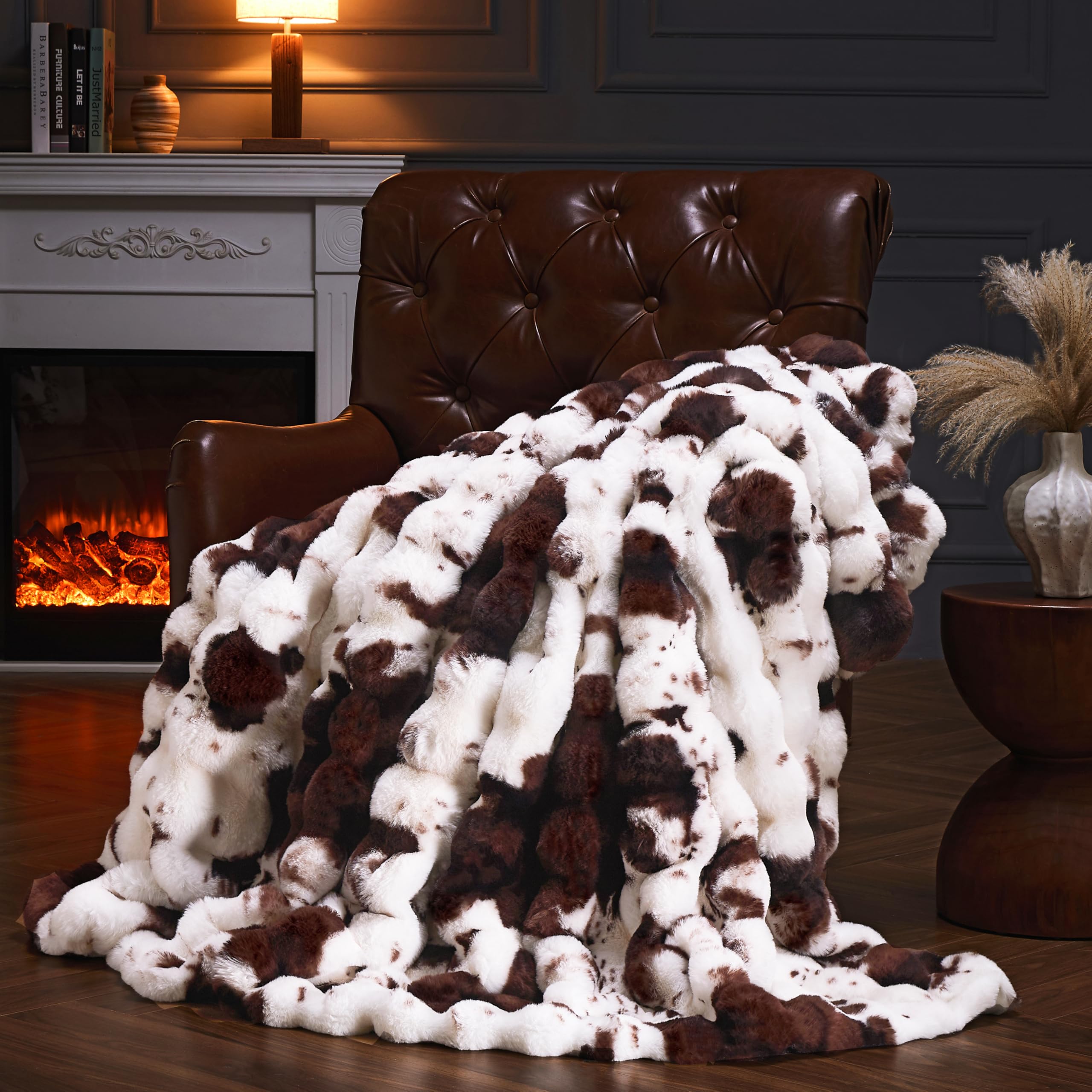 PLUUSHUU cow print brown faux fur throw on sofa adds cozy luxury.