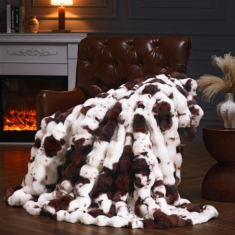 PLUUSHUU cow print brown faux fur throw on sofa adds cozy luxury.