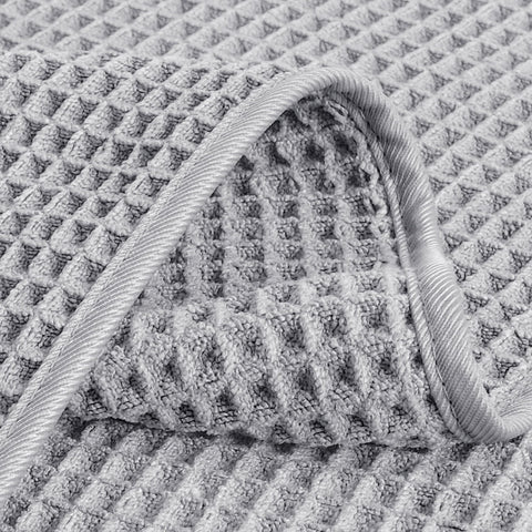 POLYTE bathroom setup shows quick-dry towels ready for travel, gym, or pool.